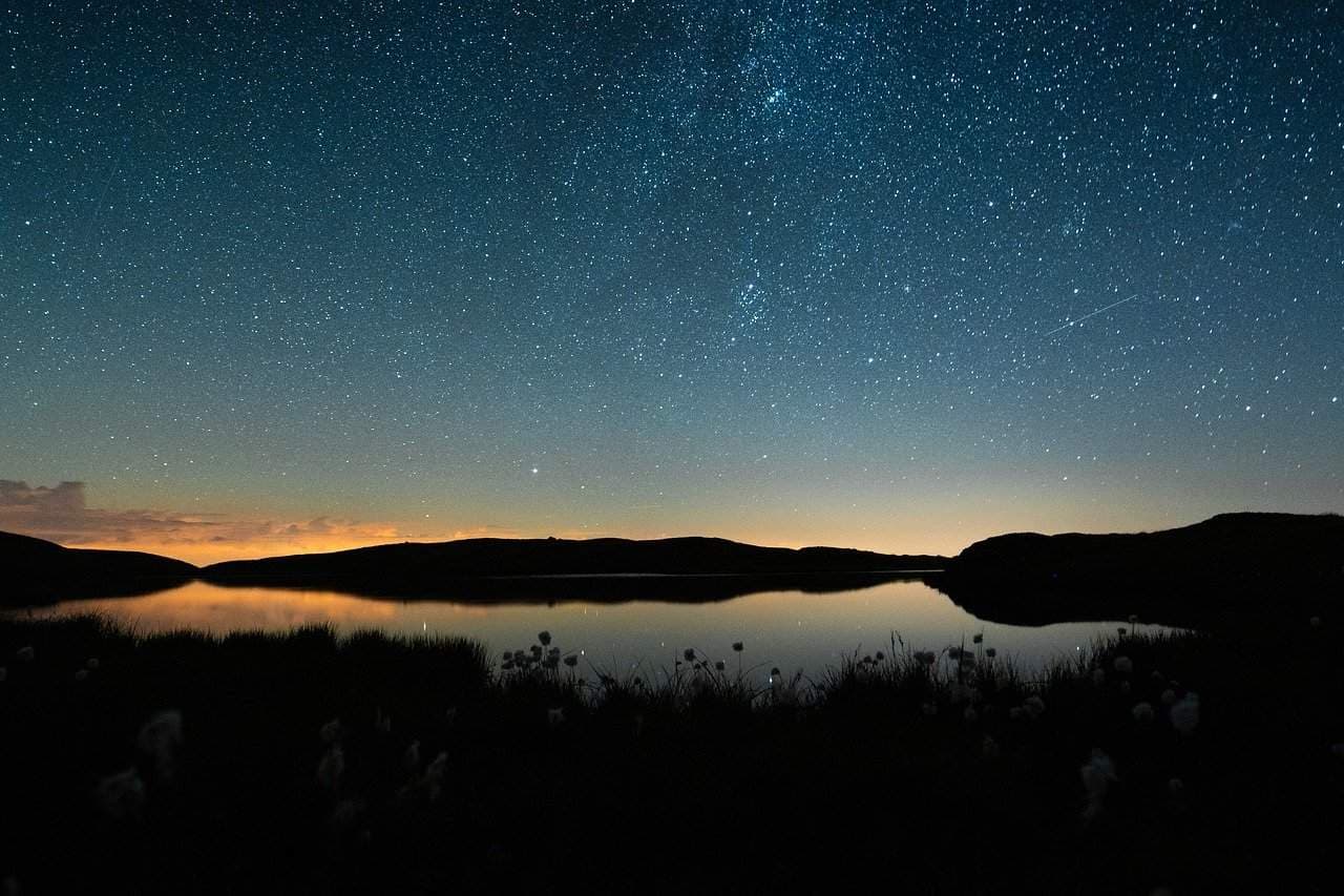 Image of mountain and sea at night